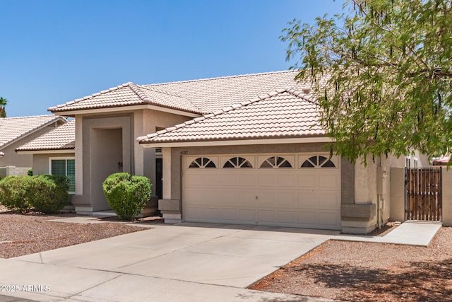 4137 E Stanford Ave, Gilbert, AZ 85234 - view of front of house featuring stucco siding, a tiled roof, an attached garage, and concrete driveway