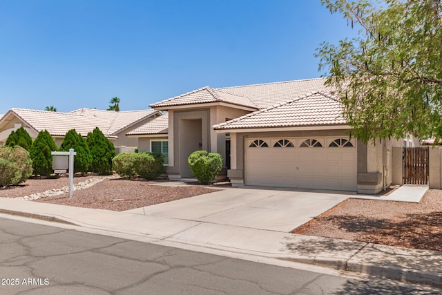 4137 E Stanford Ave, Gilbert, AZ 85234 - view of front of home featuring stucco siding, a tile roof, a garage, and concrete driveway