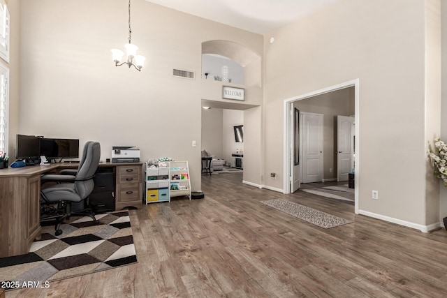 4137 E Stanford Ave, Gilbert, AZ 85234 - office with a towering ceiling, wood finished floors, and a chandelier