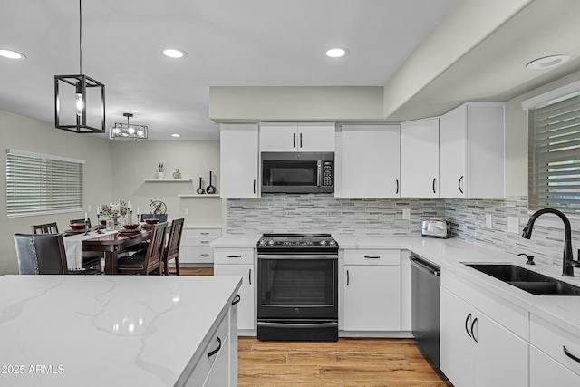 kitchen featuring black range with electric stovetop, white cabinetry, dishwasher, and sink