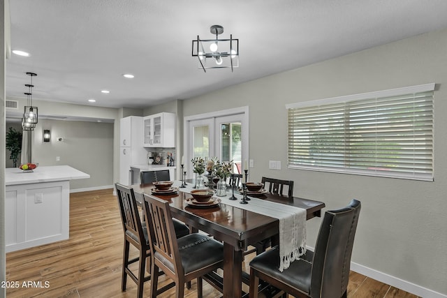 dining area featuring light hardwood / wood-style flooring and french doors