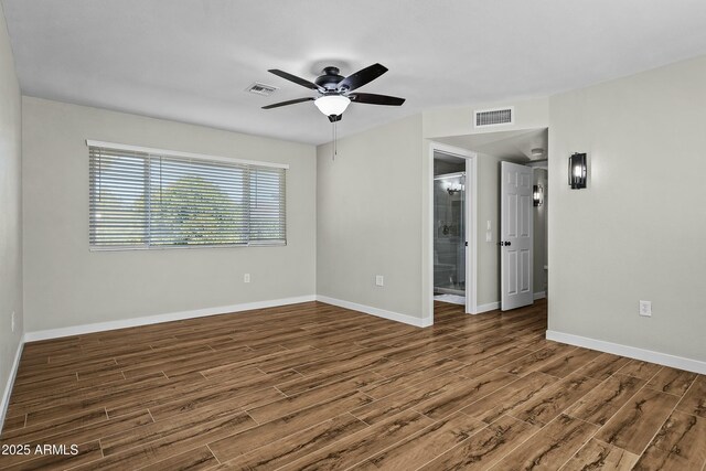 empty room featuring dark hardwood / wood-style floors and ceiling fan