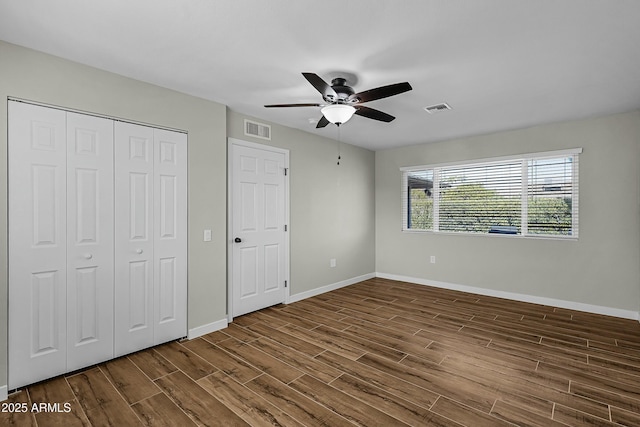 unfurnished bedroom with dark hardwood / wood-style floors and ceiling fan