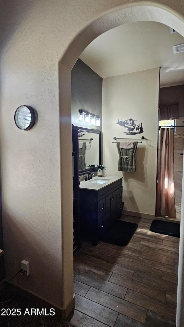 4990 N Pine Creek Canyon Dr, Pine, AZ 85544 - bathroom with wood tiled floors, vanity, and a shower with shower curtain