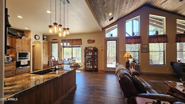 4990 N Pine Creek Canyon Dr, Pine, AZ 85544 - kitchen with stainless steel appliances, open floor plan, a chandelier, dark wood-style flooring, and dark stone countertops