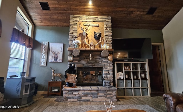 4990 N Pine Creek Canyon Dr, Pine, AZ 85544 - living area featuring wooden ceiling, wood finished floors, a wood stove, plenty of natural light, and a fireplace