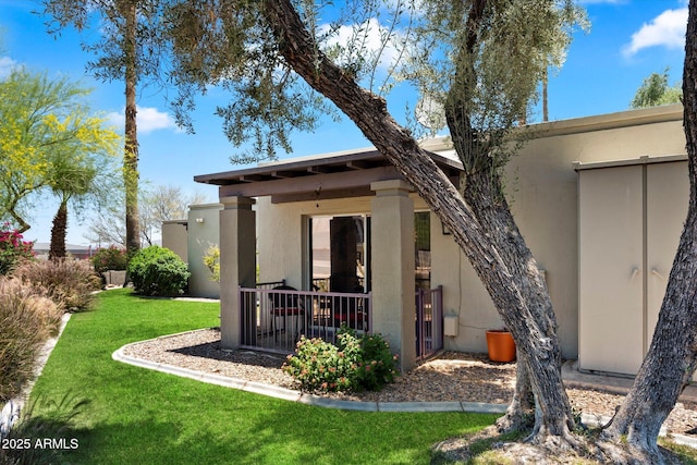 16819 E Gunsight Dr Unit A31, Fountain Hills, AZ 85268 - rear view of property featuring a lawn and stucco siding