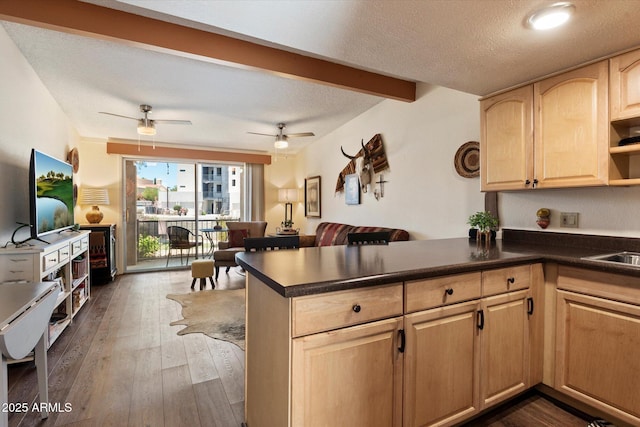 16819 E Gunsight Dr Unit A31, Fountain Hills, AZ 85268 - kitchen with light brown cabinetry, dark countertops, ceiling fan, a peninsula, and beam ceiling