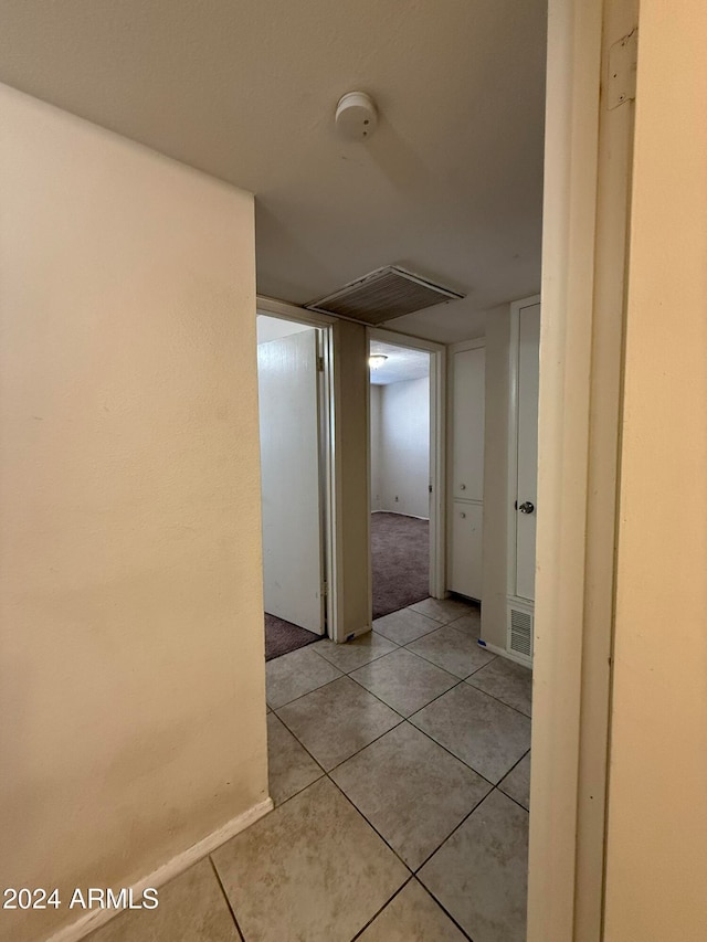 hallway featuring light tile patterned flooring