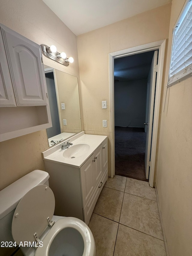 bathroom with tile patterned floors, vanity, and toilet