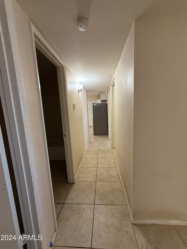 corridor featuring light tile patterned flooring