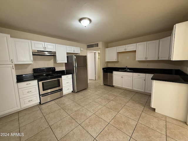 kitchen with white cabinets, light tile patterned flooring, sink, and appliances with stainless steel finishes