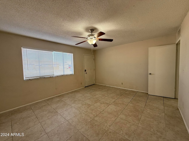 empty room featuring a textured ceiling and ceiling fan