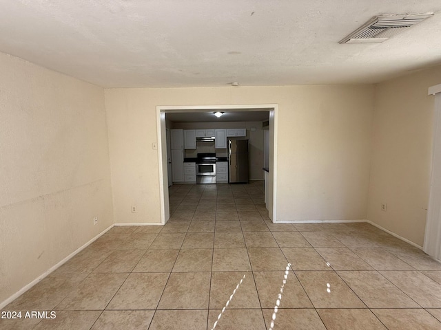 empty room with light tile patterned flooring