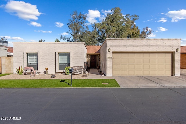 view of front of property with brick siding, concrete driveway, and a garage