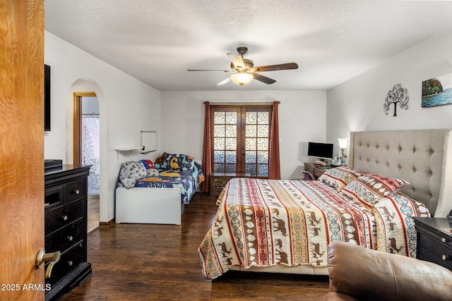 bedroom featuring ceiling fan, french doors, wood finished floors, arched walkways, and a textured ceiling