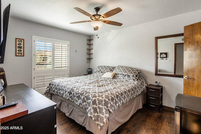 bedroom with baseboards, dark wood-type flooring, and a ceiling fan