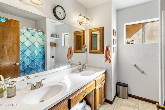 full bathroom featuring tile patterned floors, visible vents, double vanity, and a sink