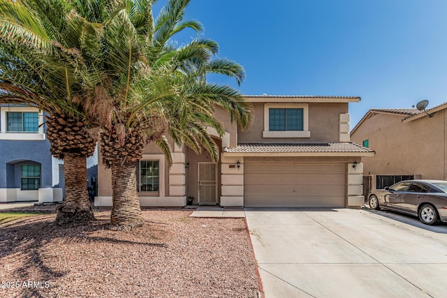 8939 W Villa Rita Dr, Peoria, AZ 85382 - view of front facade featuring stucco siding, an attached garage, concrete driveway, and a tiled roof