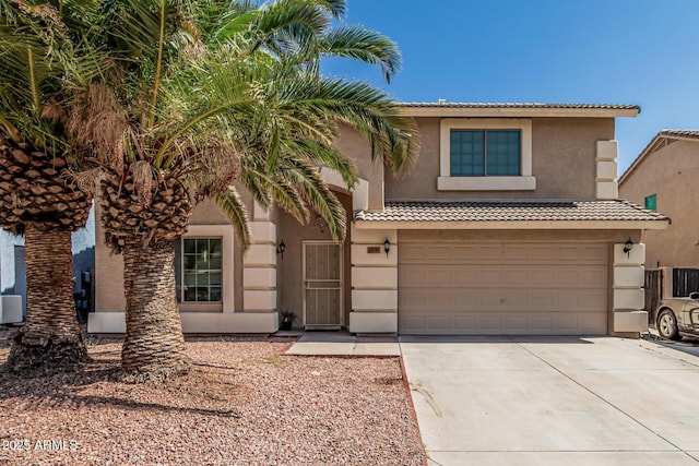 8939 W Villa Rita Dr, Peoria, AZ 85382 - view of front of house with driveway, stucco siding, a garage, and a tile roof