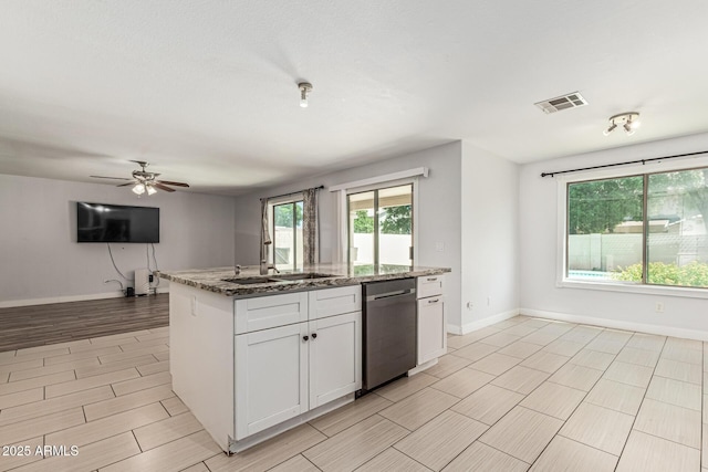 8939 W Villa Rita Dr, Peoria, AZ 85382 - kitchen featuring stainless steel dishwasher, open floor plan, light stone counters, white cabinets, and wood finish floors