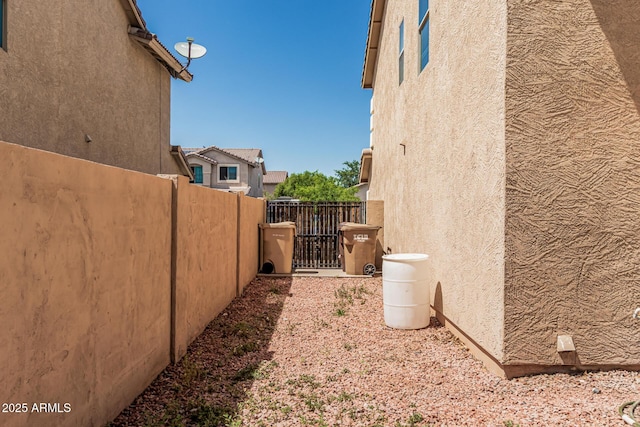 8939 W Villa Rita Dr, Peoria, AZ 85382 - view of side of property featuring stucco siding and a gate