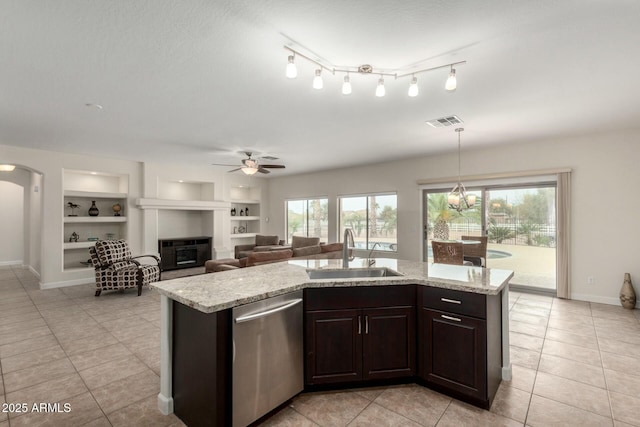 kitchen with a sink, an island with sink, dishwasher, and dark brown cabinets