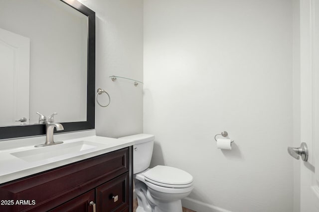 half bath featuring toilet and vanity