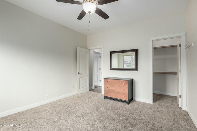 unfurnished bedroom featuring light carpet, ceiling fan, baseboards, and a closet