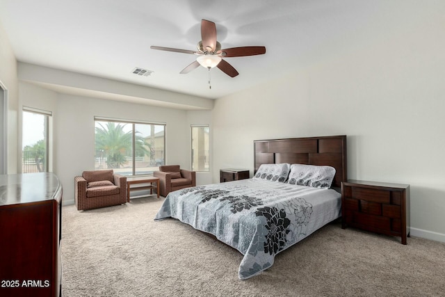 bedroom featuring carpet floors, baseboards, visible vents, and a ceiling fan