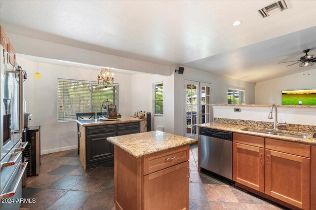 kitchen featuring sink, stainless steel dishwasher, a healthy amount of sunlight, and a kitchen island