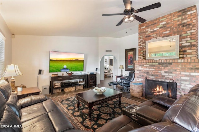 living room featuring a fireplace and ceiling fan