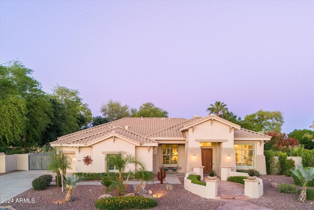 mediterranean / spanish house with a patio area