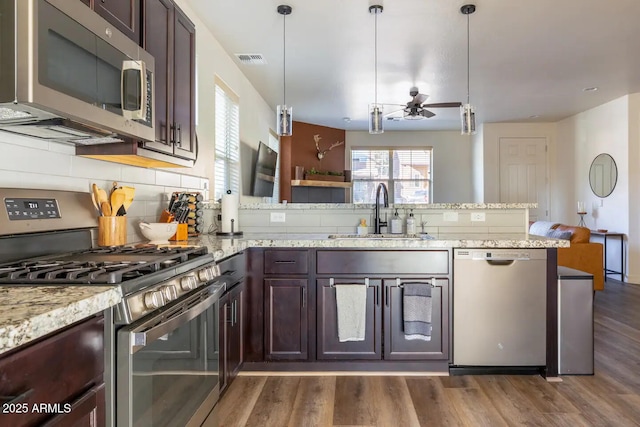 2465 W Clement Cir, Flagstaff, AZ 86001 - kitchen featuring stainless steel appliances, a sink, ceiling fan, a peninsula, and dark brown cabinets