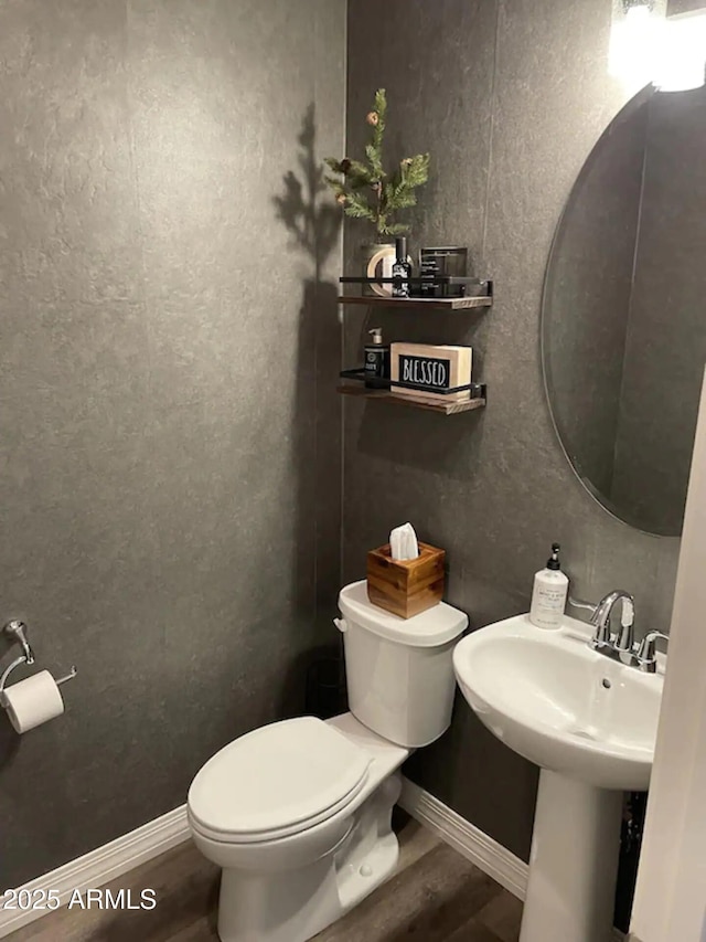 2465 W Clement Cir, Flagstaff, AZ 86001 - half bathroom with wood finished floors, toilet, baseboards, and a sink