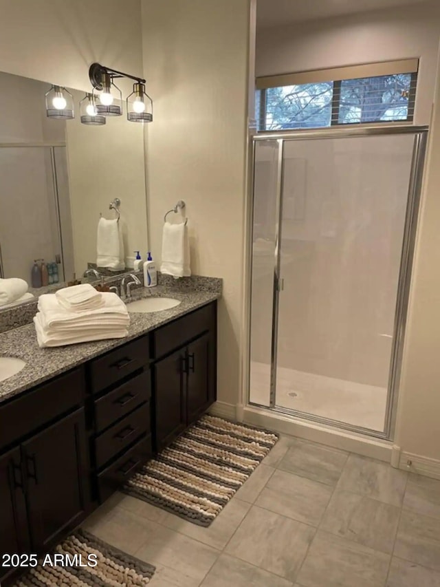 2465 W Clement Cir, Flagstaff, AZ 86001 - full bathroom featuring double vanity, a shower stall, tile patterned floors, and baseboards