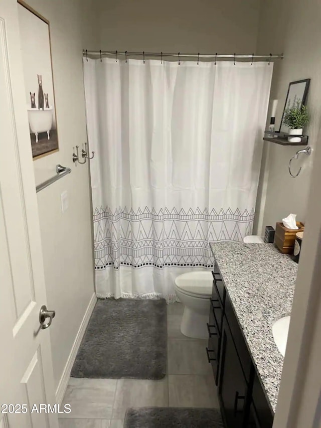 2465 W Clement Cir, Flagstaff, AZ 86001 - full bathroom with vanity, toilet, tile patterned flooring, a shower with shower curtain, and baseboards
