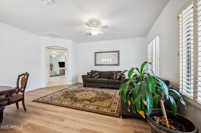 4414 W Monte Way, Laveen, AZ 85339 - living room with a ceiling fan, healthy amount of natural light, arched walkways, and wood finished floors