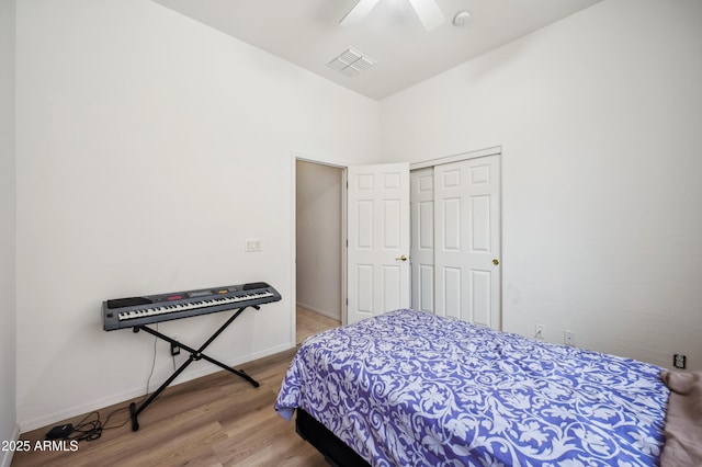 4414 W Monte Way, Laveen, AZ 85339 - bedroom with wood finished floors, a closet, baseboards, and a ceiling fan