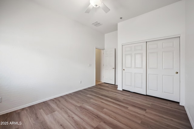 4414 W Monte Way, Laveen, AZ 85339 - unfurnished bedroom with wood finished floors, a closet, and baseboards