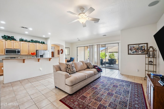 4414 W Monte Way, Laveen, AZ 85339 - living room featuring light tile patterned floors, arched walkways, ceiling fan, and recessed lighting