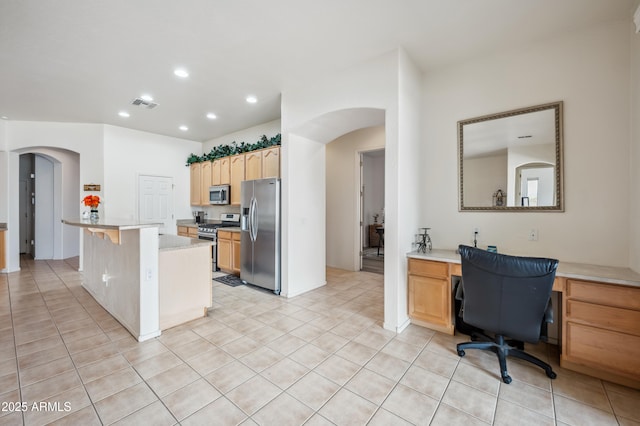 4414 W Monte Way, Laveen, AZ 85339 - kitchen with appliances with stainless steel finishes, arched walkways, light countertops, recessed lighting, and light tile patterned flooring