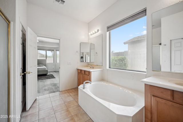 4414 W Monte Way, Laveen, AZ 85339 - ensuite bathroom featuring two vanities, a bath, and tile patterned floors