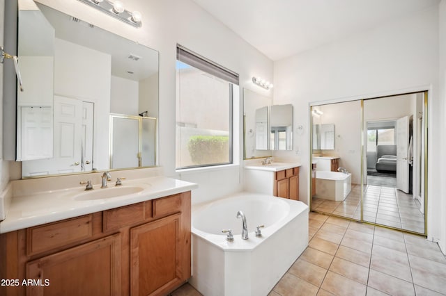 4414 W Monte Way, Laveen, AZ 85339 - bathroom featuring a bath, two vanities, a shower stall, and tile patterned flooring