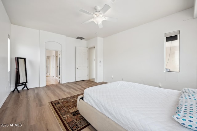 4414 W Monte Way, Laveen, AZ 85339 - bedroom featuring wood finished floors, a ceiling fan, baseboards, and ensuite bath