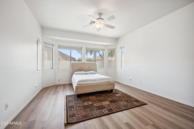 4414 W Monte Way, Laveen, AZ 85339 - bedroom with wood finished floors, baseboards, and a ceiling fan