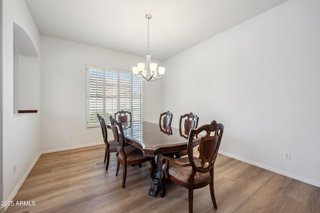 4414 W Monte Way, Laveen, AZ 85339 - dining area with light wood-style flooring, a chandelier, and baseboards