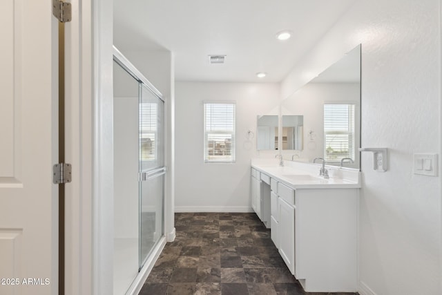 12531 W Glenn Dr, Glendale, AZ 85307 - full bathroom with plenty of natural light, double vanity, a stall shower, and stone finish floors