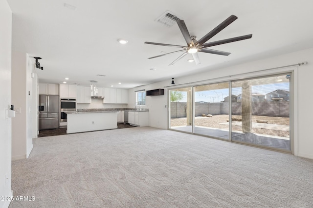 12531 W Glenn Dr, Glendale, AZ 85307 - unfurnished living room with a sink, recessed lighting, a ceiling fan, light carpet, and baseboards