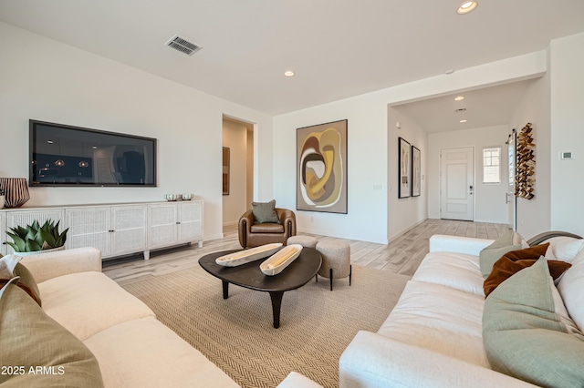 living area with recessed lighting, visible vents, and light wood-style flooring